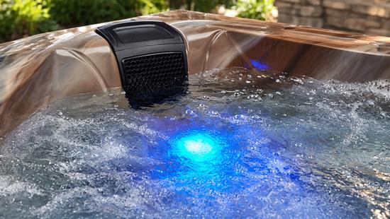 Detail shot of blue LED lighting glowing through the water at the base of the spa interior