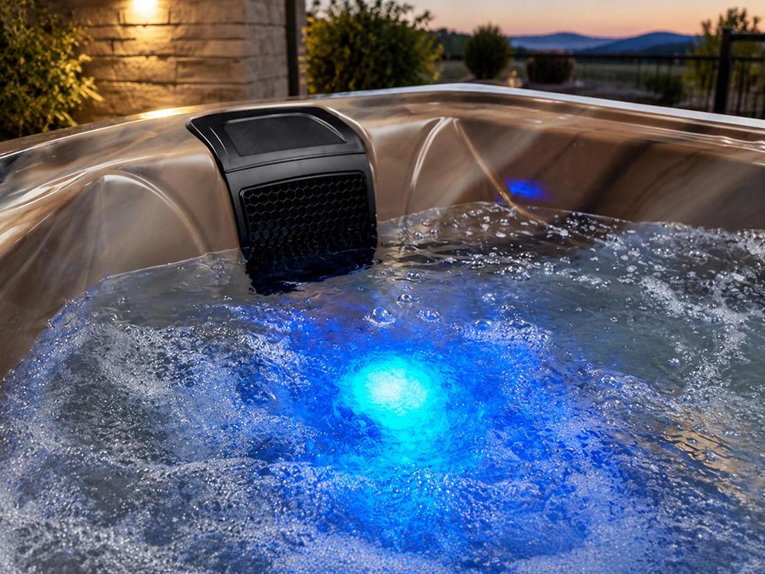Hot tub interior with blue LED lighting glowing through water