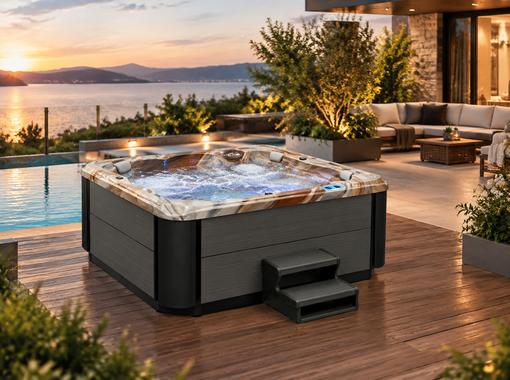 Hot tub installed on a wooden deck in a backyard setting with surrounding greenery