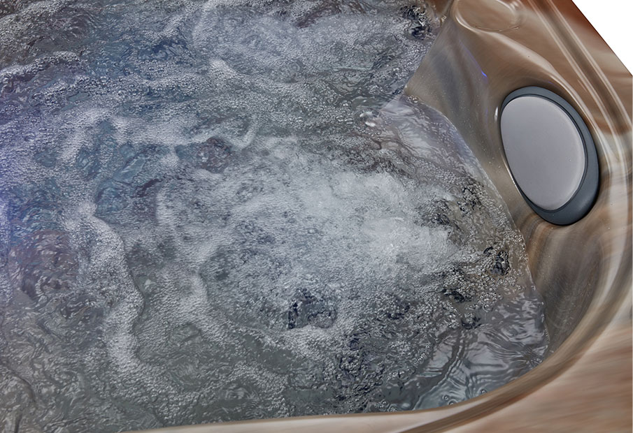 Close-up view of massage jets set into marbled acrylic wall