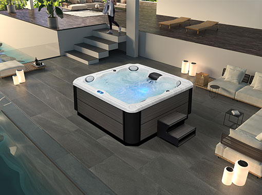 Wide-angle lifestyle shot of the spa installed in an outdoor luxury setting