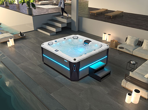 Wide-angle evening shot of a hot tub illuminated with blue LED lighting