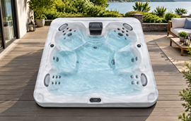 A top-down studio view of a spa shell showing marbled texture, multiple seating positions, and jet placement