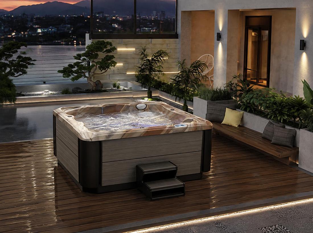 A 45-degree high-angle shot of the hot tub installed on a wooden deck in a luxury backyard with lush greenery
