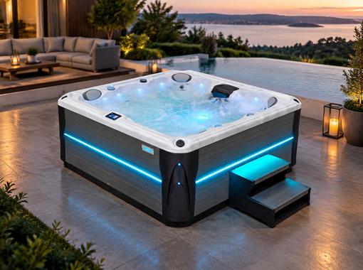 Hot tub with blue LED lighting on a stone patio at night