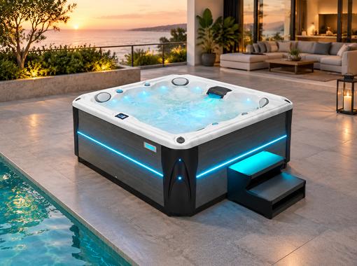 Evening view of the hot tub illuminated with blue LED lighting on a stone patio