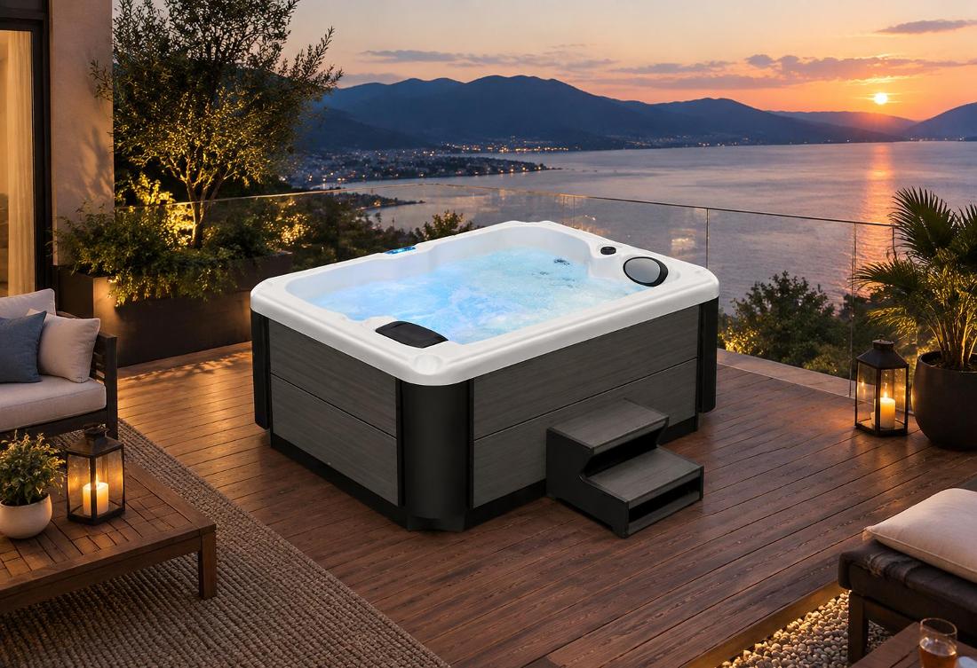 High-angle view of a hot tub with blue LED lighting on a stone patio at night