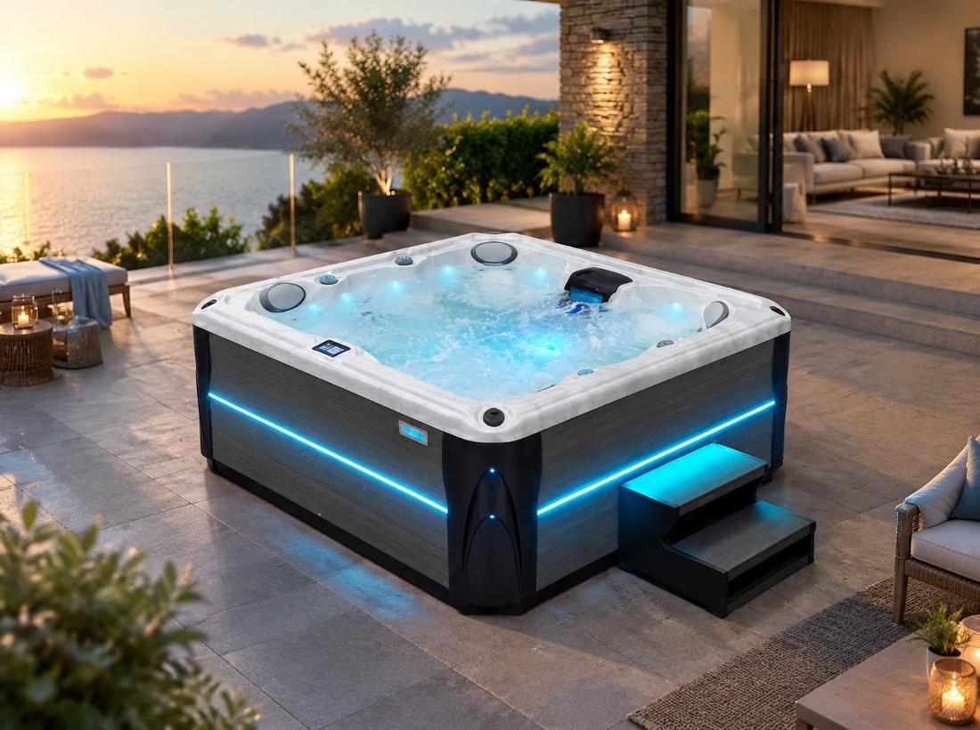 Evening view of the spa with blue LED lighting glowing against a stone patio