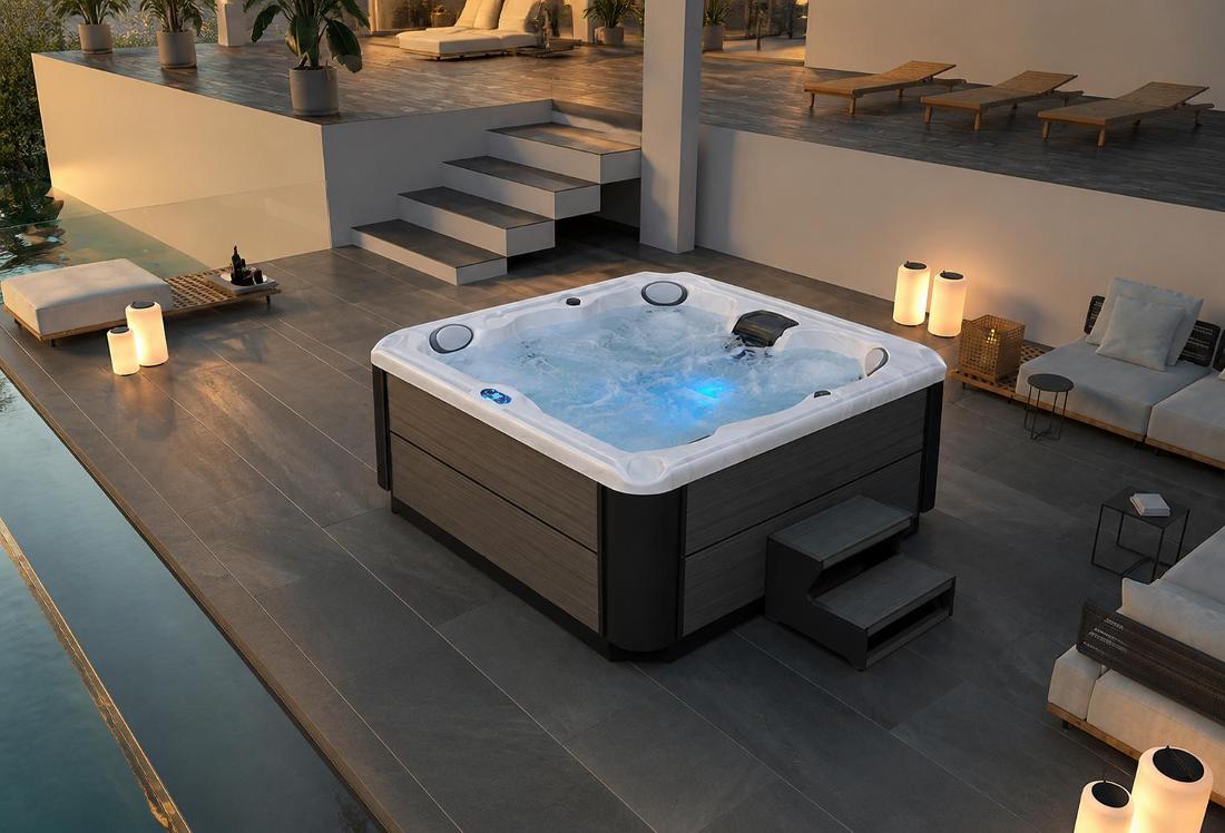 High-angle wide shot of the BD-001 hot tub installed on a dark stone patio