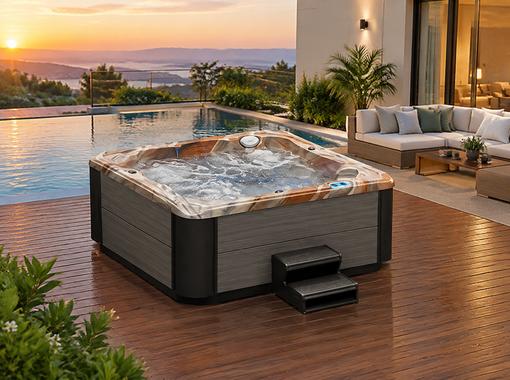 The spa installed on a wooden deck surrounded by greenery in a backyard setting