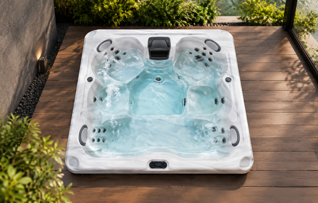 Top-down studio view of a spa shell showing jet placement and central filtration housing